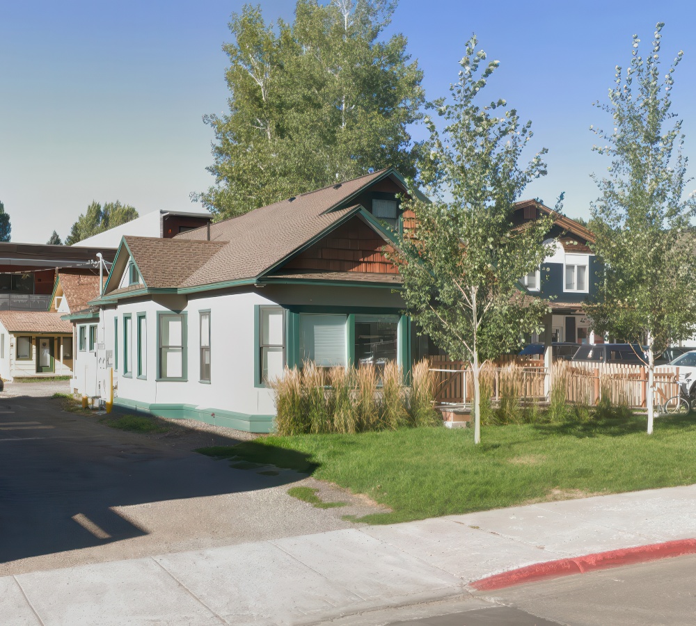 A charming pre school surrounded by trees and greenery, showcasing a welcoming exterior in a friendly way.