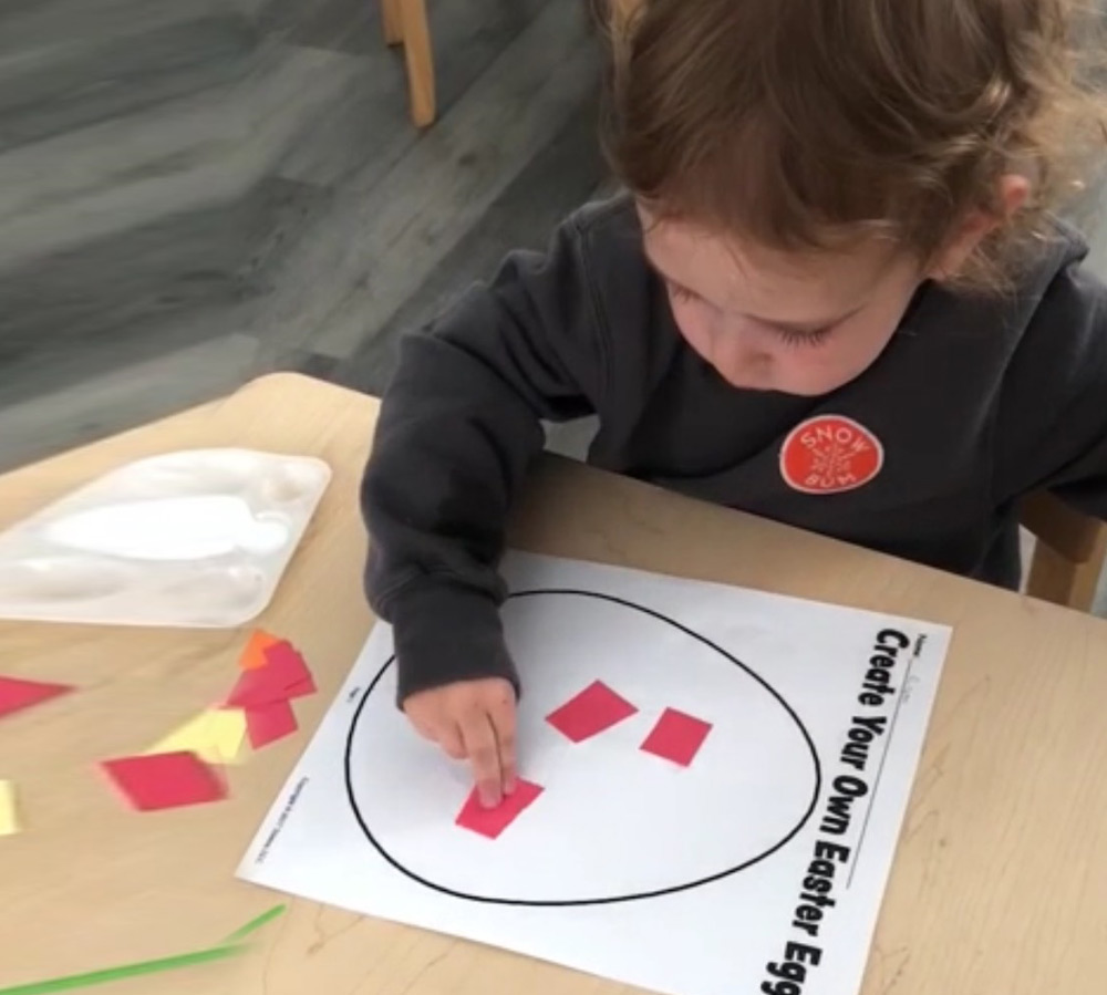A organized classroom displays colorful toys, a rug, and educational materials, creating an inviting learning space.